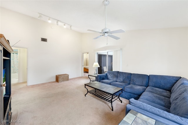 living room featuring high vaulted ceiling, carpet, track lighting, and ceiling fan