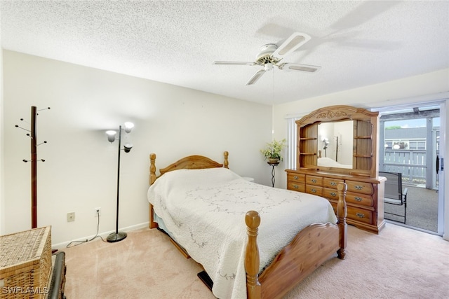 carpeted bedroom featuring ceiling fan, a textured ceiling, and access to outside