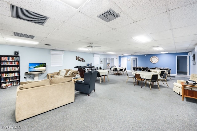 living room featuring ceiling fan, a paneled ceiling, and carpet flooring