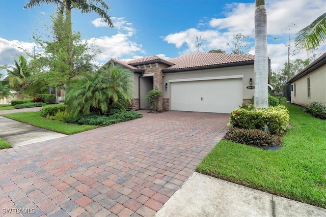 mediterranean / spanish home with a garage and a front yard