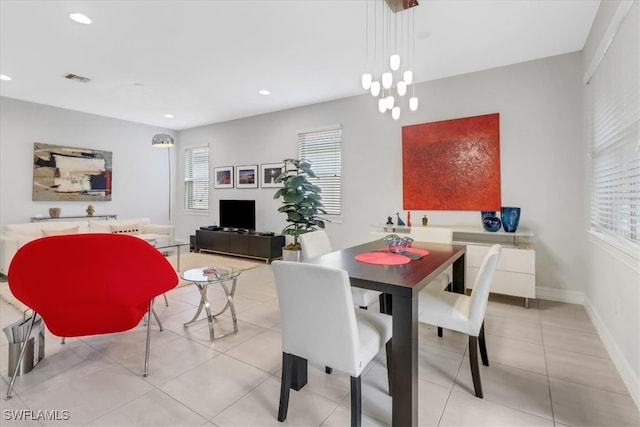 dining space featuring a notable chandelier and light tile patterned floors