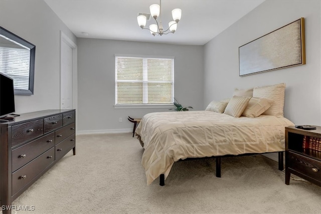 carpeted bedroom featuring an inviting chandelier