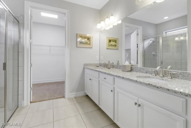 bathroom featuring vanity, an enclosed shower, and tile patterned flooring