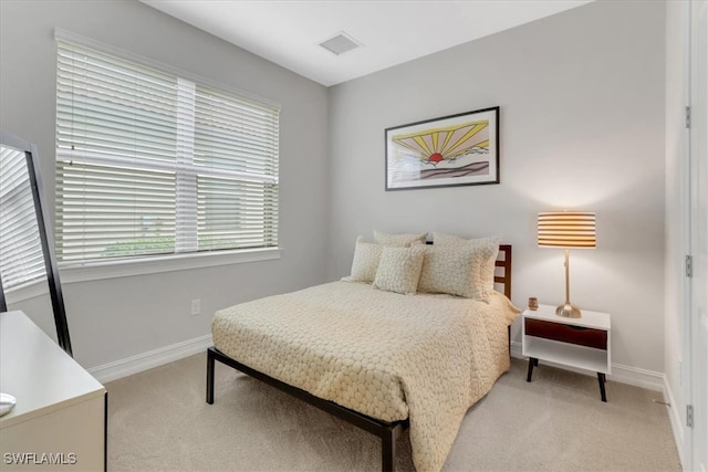 bedroom featuring light carpet