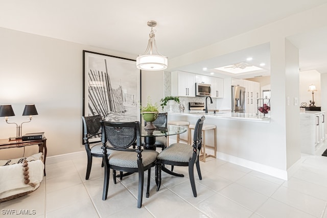 tiled dining space featuring sink