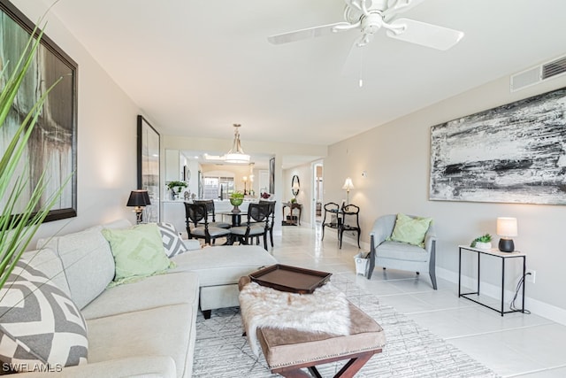 living room featuring light tile patterned floors and ceiling fan