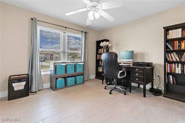 home office featuring light hardwood / wood-style floors and ceiling fan