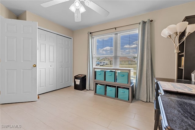 bedroom with a closet, ceiling fan, and light hardwood / wood-style floors