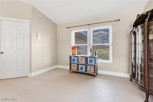 empty room with vaulted ceiling