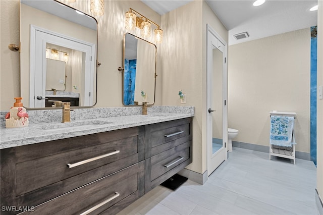 bathroom with vanity and toilet