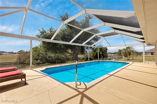 view of swimming pool featuring a patio area and a lanai