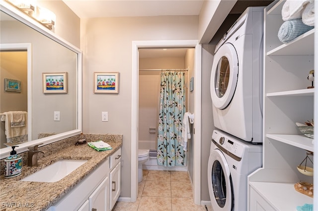 laundry room with sink, light tile patterned floors, and stacked washer / drying machine