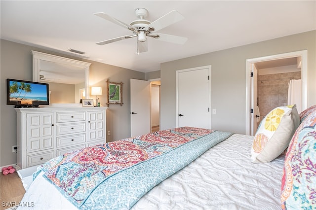 bedroom featuring connected bathroom, hardwood / wood-style flooring, and ceiling fan