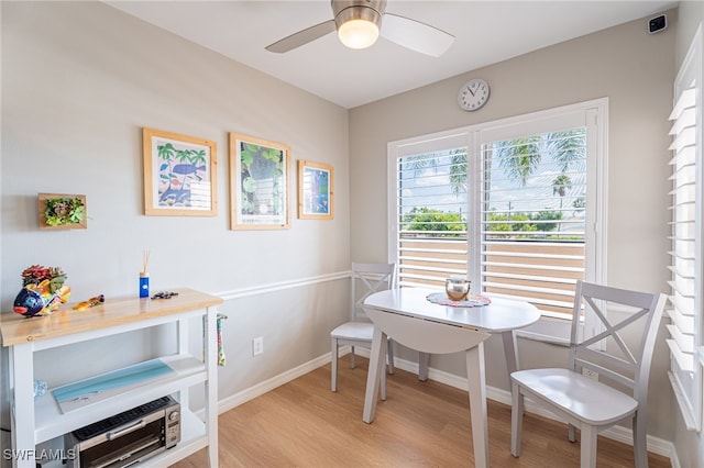 dining space featuring ceiling fan, breakfast area, and light hardwood / wood-style floors