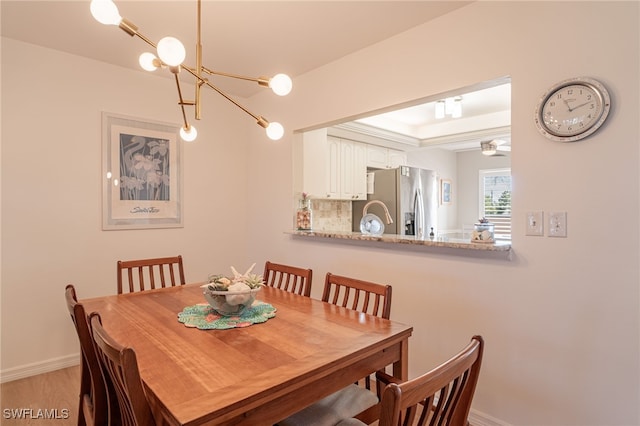 dining room featuring a notable chandelier and light wood-type flooring