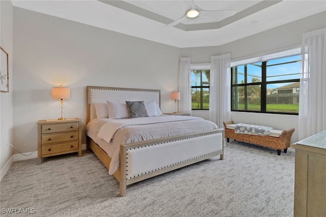 bedroom featuring ceiling fan and a raised ceiling