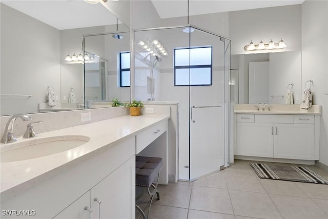 bathroom with tile patterned flooring, a shower with shower door, and vanity