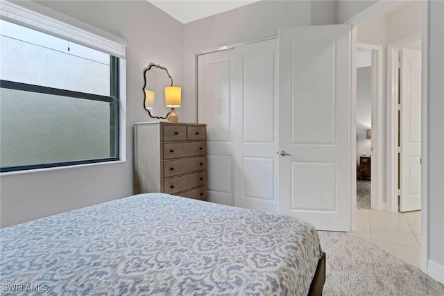 bedroom featuring a closet and light tile patterned flooring