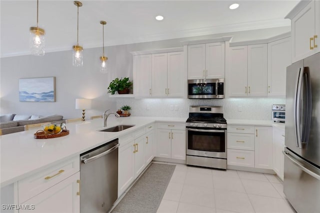 kitchen with white cabinets, sink, stainless steel appliances, and pendant lighting