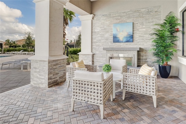 view of patio / terrace with an outdoor stone fireplace