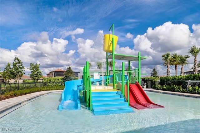 view of swimming pool with a playground