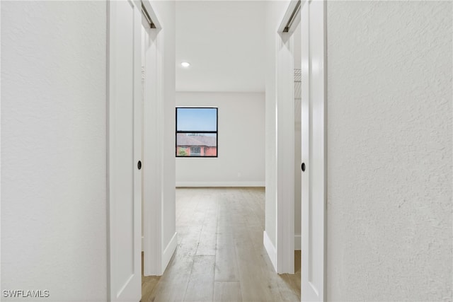 hall with light hardwood / wood-style flooring