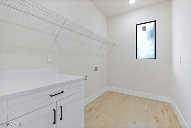 laundry room featuring light hardwood / wood-style flooring and washer hookup