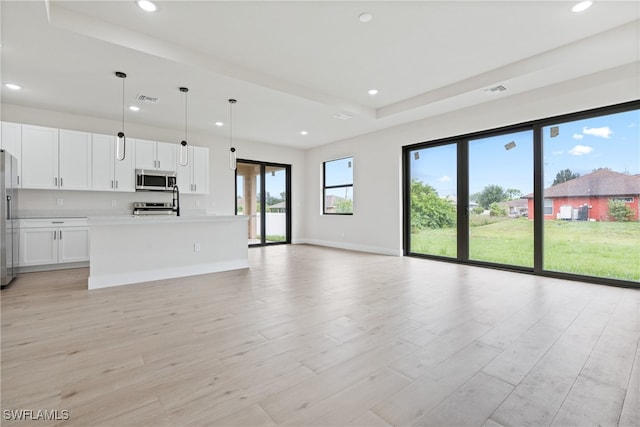 unfurnished living room featuring light wood-type flooring