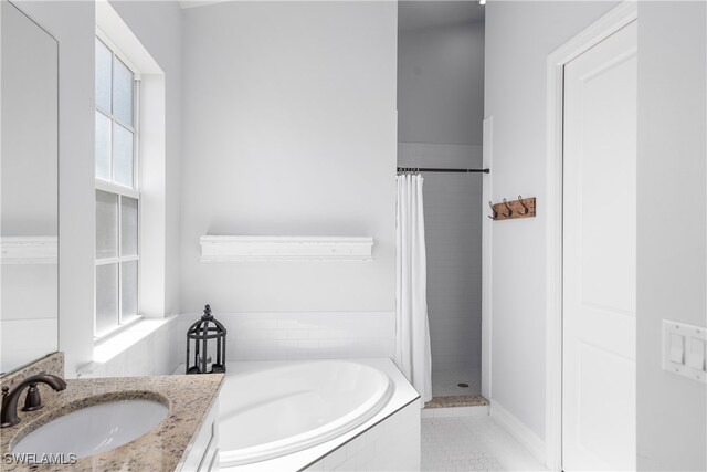 bathroom with vanity, shower with separate bathtub, and tile patterned floors