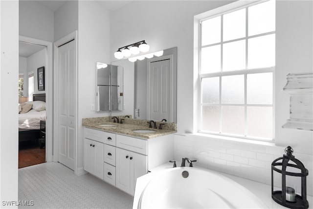 bathroom featuring vanity and a bath