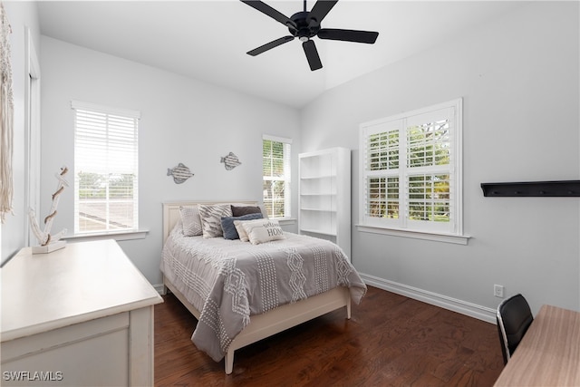 bedroom with ceiling fan, lofted ceiling, and dark hardwood / wood-style floors