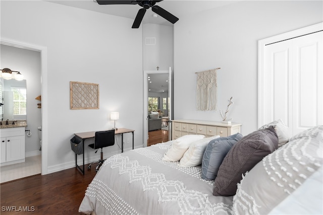 bedroom with sink, dark wood-type flooring, ensuite bathroom, and ceiling fan