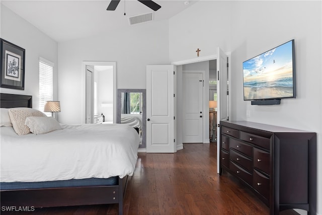 bedroom featuring dark wood-type flooring, ceiling fan, vaulted ceiling, and ensuite bathroom