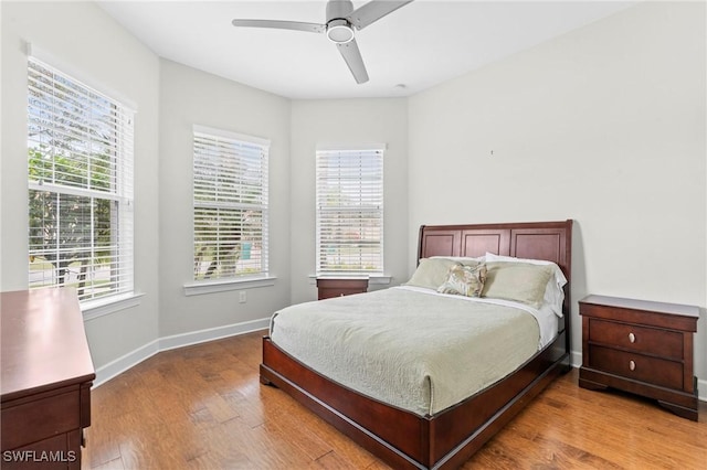 bedroom with ceiling fan and hardwood / wood-style flooring