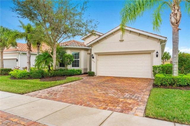 view of front of home with a garage and a front lawn