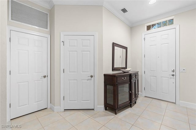 foyer featuring ornamental molding and light tile patterned floors