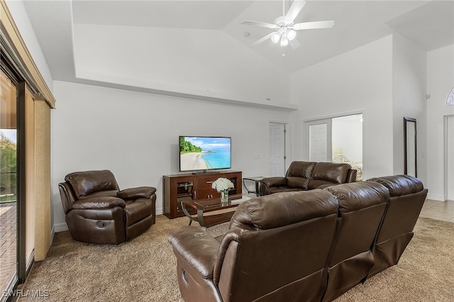 living room with light colored carpet, high vaulted ceiling, and ceiling fan