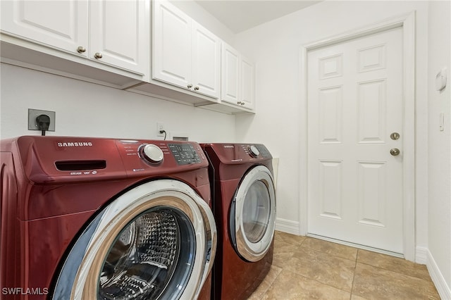 laundry room with cabinets, independent washer and dryer, and light tile patterned floors