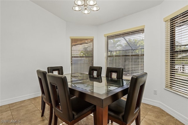 dining room featuring an inviting chandelier and light tile patterned floors