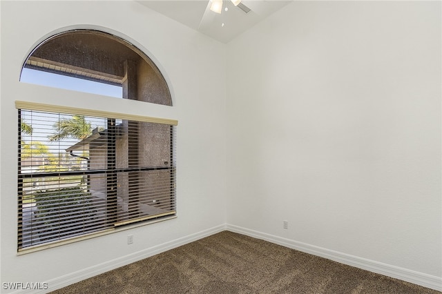 carpeted empty room featuring vaulted ceiling