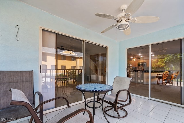 sunroom featuring ceiling fan