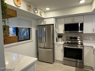 kitchen featuring decorative backsplash and stainless steel appliances