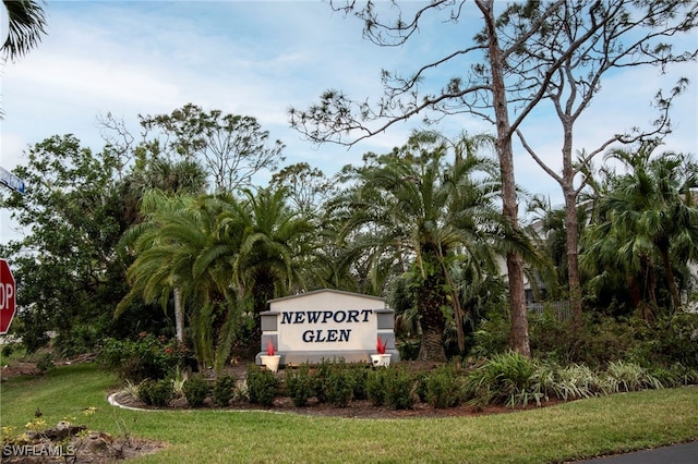 community / neighborhood sign with a lawn