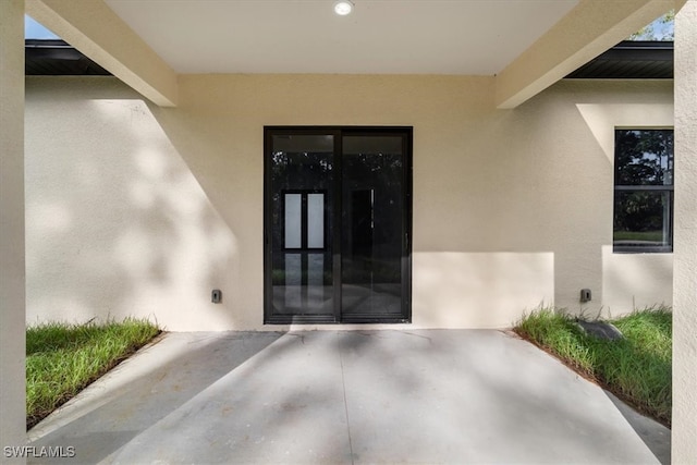 property entrance with a patio area