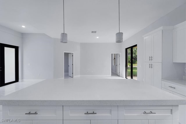 kitchen with white cabinetry, a center island, and pendant lighting