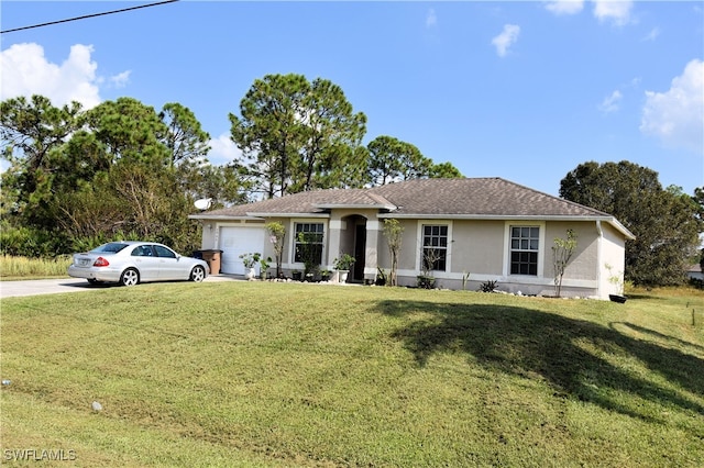 ranch-style house featuring a front yard and a garage