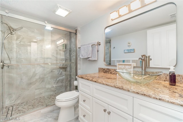 bathroom featuring vanity, toilet, and an enclosed shower