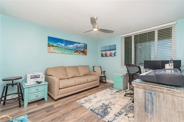 office with ceiling fan and light hardwood / wood-style flooring