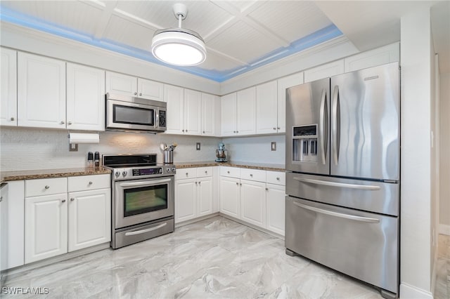 kitchen with ornamental molding, white cabinetry, appliances with stainless steel finishes, stone counters, and decorative backsplash