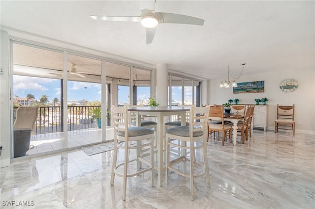 dining room with ceiling fan with notable chandelier